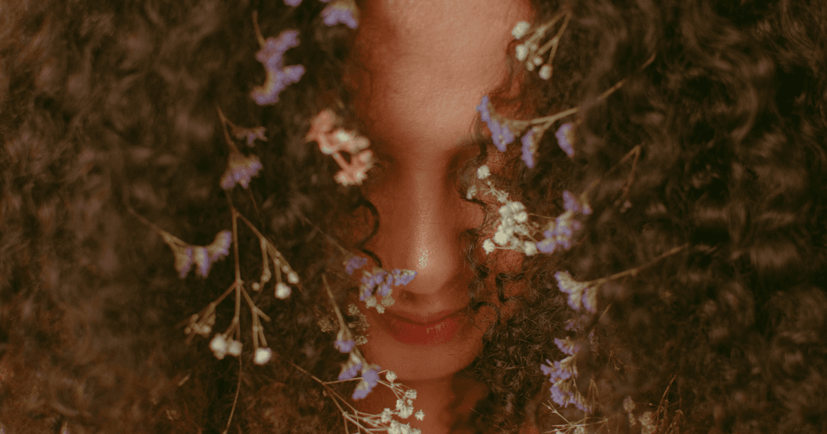 Cannamom | Woman with Dark Curly Hair, Flowers Woven In