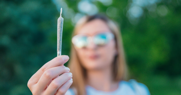 Photo of a woman holding a joint